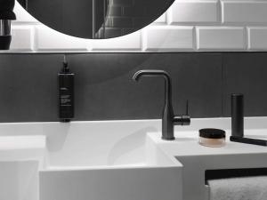 a bathroom sink with a faucet and a mirror at ibis Brussels Centre Chatelain in Brussels