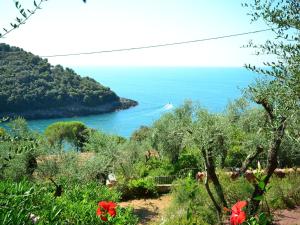a view of the ocean from a hill with flowers at Belvilla by OYO Villa Shakti in Lerici