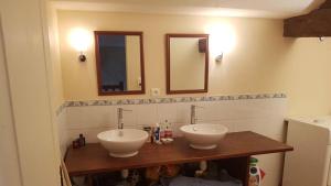 łazienka z 2 umywalkami i 2 lustrami w obiekcie La Truffiere w mieście Champigny-sur-Veude
