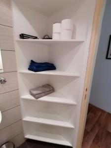 a closet with white shelves in a bathroom at Apartment U Panorámy in Jáchymov