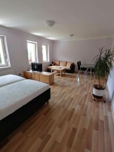 a bedroom with a bed and a living room at Apartment U Panorámy in Jáchymov