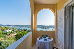 a table on a balcony with a view of the water at Elite Corfu - Adults Friendly in Kommeno