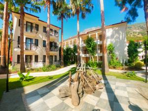 a building with palm trees in front of it at Sundia By Liberty Oludeniz in Oludeniz