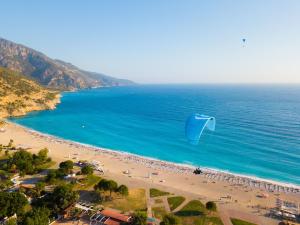 a person flying a kite on a beach at Sundia By Liberty Oludeniz in Oludeniz