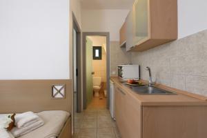 a small kitchen with a sink and a microwave at Maistrali Apartments in Ormos Panagias +40 photos