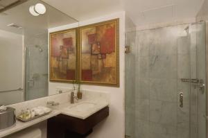 a bathroom with a sink and a shower at The Historic Blue Angel Hotel Lexington Ave, Ascend Hotel Collection in New York