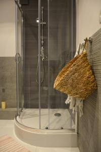 a shower with a glass door in a bathroom at Apartament Centrum Warszawy in Warsaw