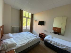 a hotel room with a bed and a mirror at CoronaZeist-Utrecht NL in Zeist