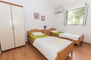 a small room with two beds and a window at Villa Ozzi with 9 bedrooms & private Pool in Makarska +49 photos