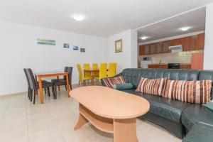 a living room with a couch and a table at Villa Ozzi with 9 bedrooms & private Pool in Makarska
