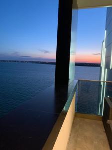 a view of the water from the balcony of a building at Apartament Alexandra in Mamaia