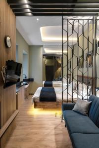 a bedroom with two beds and a tv and a couch at Pushkinskaya Apartments in Kyiv