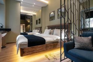 a bedroom with a large bed and a couch at Pushkinskaya Apartments in Kyiv