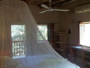 a bedroom with a bed with a mosquito net at Nour El Gourna in Luxor