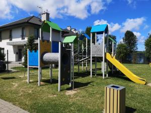 a group of playground equipment in a park at Apartament MATEO- Rezydencja Ustronie Morskie in Ustronie Morskie