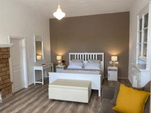 a bedroom with a white bed and a couch at Thodoris Infinity View Apartments in Symi +59 photos