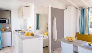 a kitchen with a counter with oranges on it at Camping Paradis Aloé in Médis