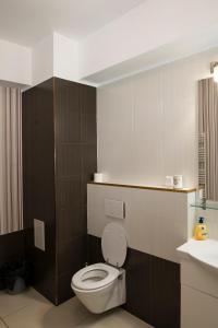 a bathroom with a toilet and a sink at Green Lake Apartment 5 in Mamaia