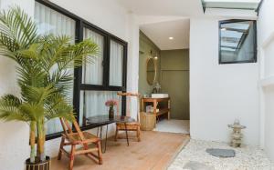 a living room with a table and a plant at YOLO Bangkok Boutique Hotel in Bangkok