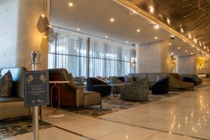 a lobby with couches and tables in a building at The Leonardo in Johannesburg