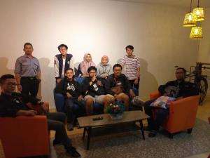 a group of people posing for a picture in a room at Home Addicts Hostel in Yogyakarta