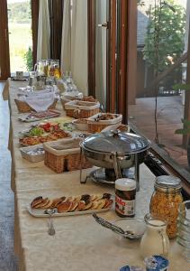 Una mesa larga con platos de comida encima. en Penzión TOKAJ MACIK WINERY Guesthouse, en Malá Tŕňa