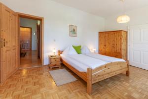 a bedroom with a large bed and a hallway at Gasthof Siegfried Gruber in Hartmannsdorf