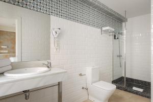 a white bathroom with a sink and a toilet at YIT Casablanca in Granada