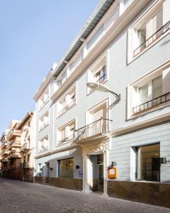 a white building with a street light next to it at YIT Casablanca in Granada