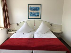 Postel nebo postele na pokoji v ubytování Hotel Haus am Rieth