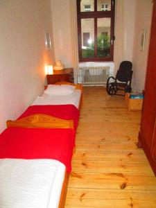 2 Betten in einem Zimmer mit Holzboden in der Unterkunft Ruhige Ferienwohnung - Berlin Mitte in Berlin
