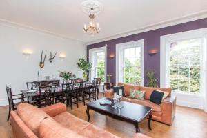 a living room with a couch and a table at Georgian Townhouse in Bristol