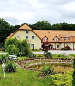 a large building with a pond in front of it at Hotel Magnat in Ostrowiec Świętokrzyski