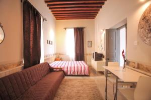 a living room with a couch and a bed at St. Lazaros Studios in Larnaca