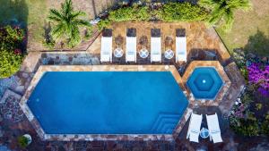 an overhead view of a swimming pool with two chairs at BEACH DREAMS in Virgin Gorda