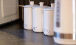 a row of white containers sitting on a table at Church View Apartments in Weymouth