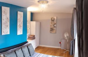 a bedroom with blue walls and a blue wall at Church View Apartments in Weymouth