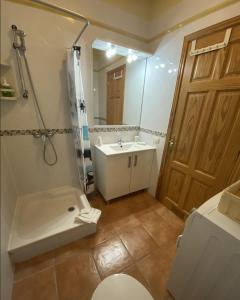 a bathroom with a sink and a tub and a toilet at Ático Los Ángeles Min 3 nights in Puerto de Santiago