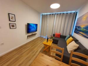 a living room with a couch and a table at Boutique Apartments Caesarea in Caesarea
