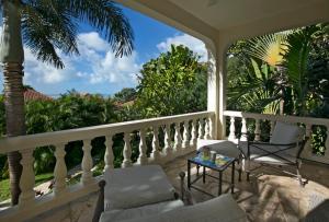a porch with a table and chairs on a balcony at BELLAMARE in Virgin Gorda +4 photos