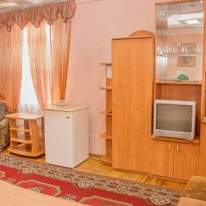 a living room with a small refrigerator and a tv at Готельний комплекс Самікс in Kyiv