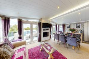a living room with a couch and a table at Tattershall VIP Lodge- Lakeside setting with hot tub and private fishing peg situated on Osprey lake tattershall park in Tattershall