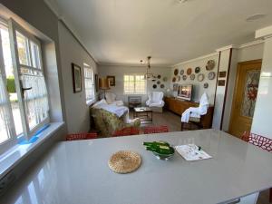 a kitchen with a table and a living room at CASA QUINTANA in Salamir