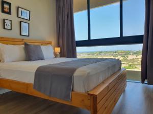 A bed or beds in a room at Boutique Apartments Caesarea
