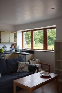 a living room with a couch and a table at Dolphin View Hillockhead in Rosemarkie