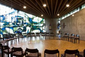 a large room with chairs and a large mural at Wasserburg Rindern in Kleve