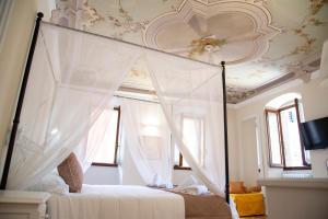 多莫多索拉Dimora Domese的一间卧室设有天蓬床和天花板