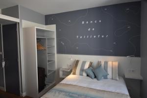 a bedroom with a bed with a blue wall at Hotel Atlantique in Le Palais