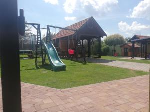 a playground with a slide in a park at Penzion Kozak B&B in Sebedražie