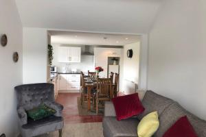 a living room with a couch and a kitchen at Rooneys @ Ballymagreehan Explore and Unwind in Castlewellan +21 photos